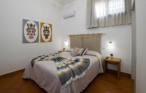 a bedroom with a bed with a blanket on it at Capo Rama Suites & Rooms in Terrasini