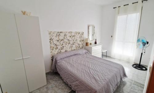 a white bedroom with a bed and a dresser at Villa Izael AT-BA-00317 in Talavera la Real