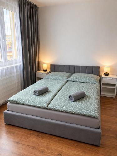 a bedroom with a bed with two pillows on it at Pohodlný apartmán s klímou blízko centra Prievidza in Prievidza