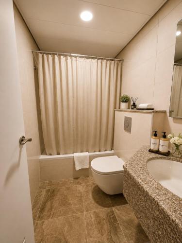 a bathroom with a toilet and a sink at The Annexe - by Gloria Hotel in Jerusalem