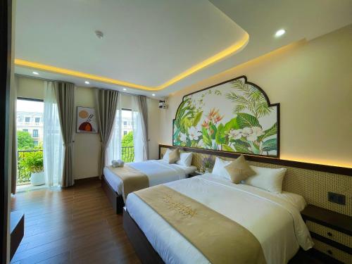a bedroom with two beds and a painting on the wall at Vin Luxury Hotel in Quang Tri