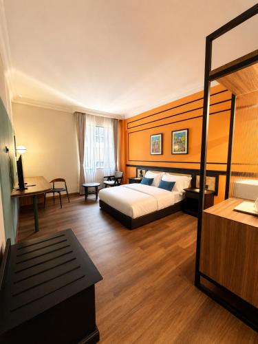 a hotel room with a bed and a desk at KL International Hotel in Kuala Lumpur
