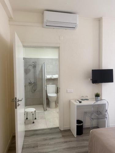 a white bathroom with a shower and a toilet at Hotel D'Alcoutim in Alcoutim