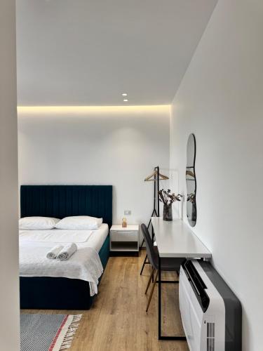 a bedroom with a bed and a table and a desk at Natyra e Qetë Hideaway in Lezhë