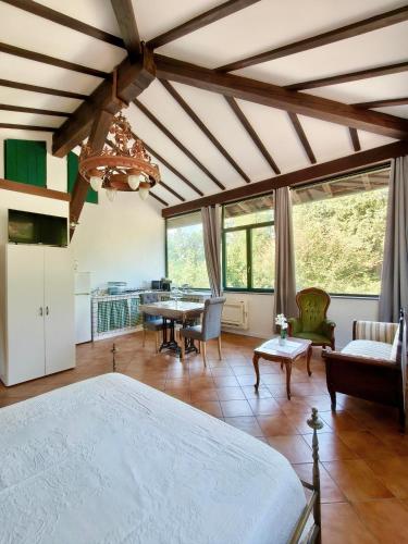 a bedroom with a bed and a dining room at Il giardino delle cince in Borgo Ticino
