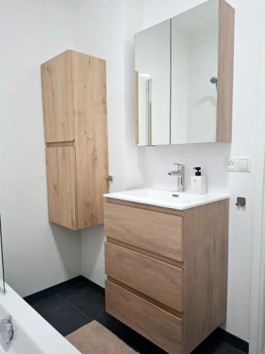 a bathroom with a sink and a mirror at Apartment with skyline view in Eindhoven