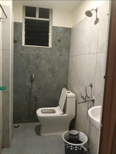 a bathroom with a toilet and a sink at HoTEL MADHAVI ELITE in Vijayawāda