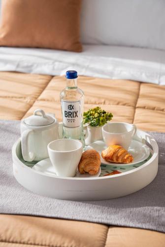 a tray with a drink and croissants on a bed at BRIX Hotel in Arequipa