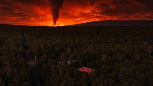 an aerial view of a house in a forest at sunset at Stop Looking You've found it in Volcano