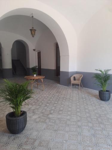 a room with two potted plants and a table at Relais Soleil in Vico Equense