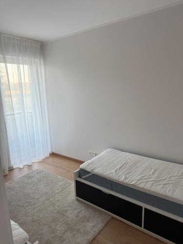 a bedroom with a bed and a large window at Apartament Bald1 in Kąty Wrocławskie