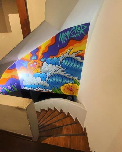a mural on the side of a stairwell at Lanni House in Huanchaco