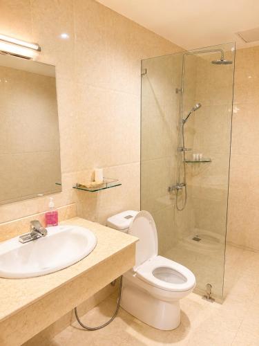 a bathroom with a sink and a toilet and a shower at Royal ANAN Hotel in Ninh Binh