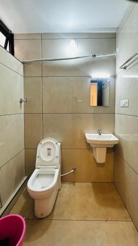 a bathroom with a toilet and a sink at AIDAN RESIDENCY - AC Premium Rooms in Alwaye