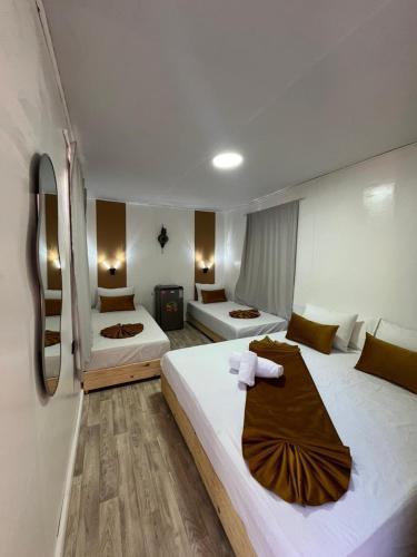 a hotel room with two beds and a fireplace at Auberge de Chez Momo in Asilah
