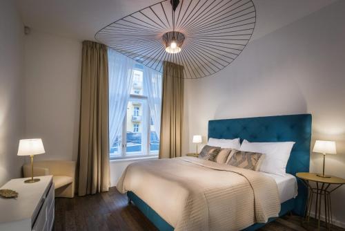 a bedroom with a large bed and a large window at Luxury Modern Designed Oldtown Apartment in Prague