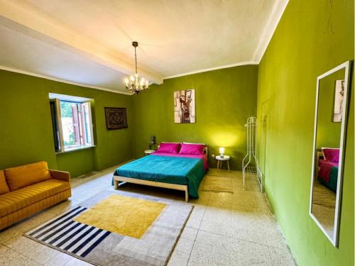 a green bedroom with a bed and a couch at Wayra Glider Norma Centro in Norma