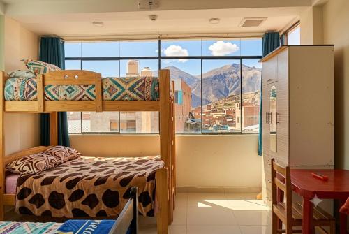 a bedroom with a bunk bed and a large window at Depawanka 2 in Huancayo