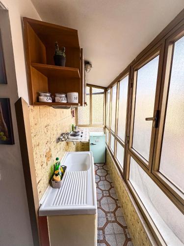 a small kitchen with a sink and a window at Wayra Glider Norma Centro in Norma