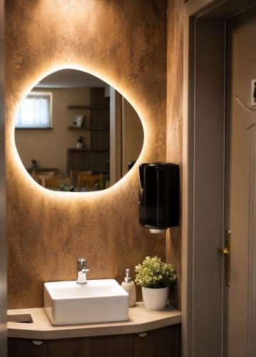 a bathroom with a sink and a mirror at Alfréd Panzió in Budapest