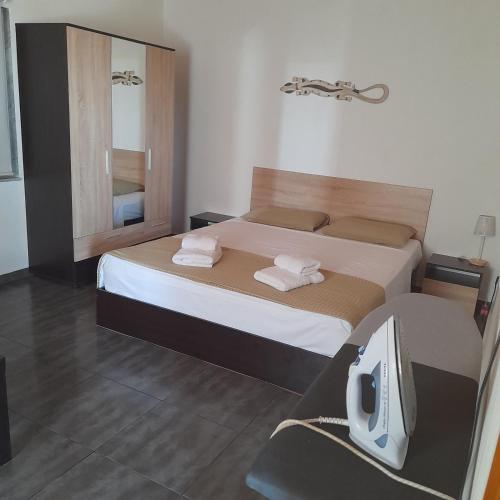 a bedroom with a bed and a tv in it at Makri Vacation House in Alexandroupoli