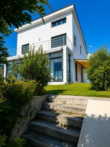 a white house with stairs in front of it at Blanca Mañana in Ribeira