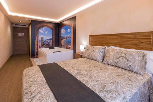 a bedroom with a large bed and a bathroom at Artilles Suites in Peniscola