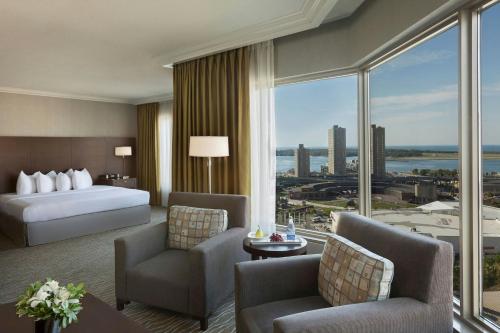a hotel room with a bed and a large window at InterContinental Toronto Centre by IHG in Toronto