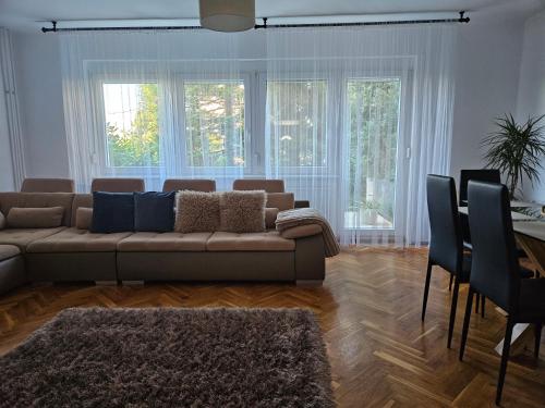 a living room with a couch and a table at FAMILLE Apartman in Tapolca
