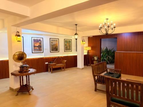 a lobby with a waiting room with a table and chairs at Lion Resort in Polonnaruwa