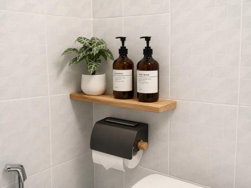 two bottles of wine on a shelf in a bathroom at Ava Beach Pakbara in Ban Pak Ba Ra
