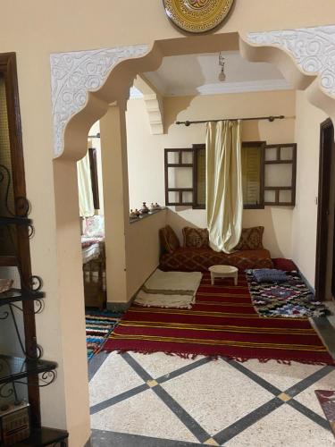 a living room with a couch and a rug at Aberge Tigmenon Ouirgane in Ouirgane