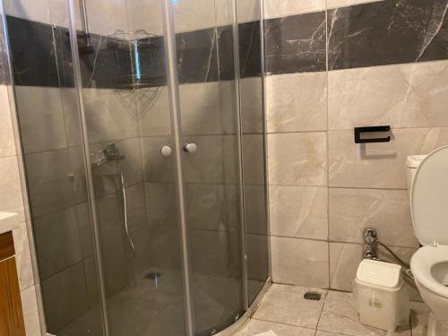 a shower stall in a bathroom with a toilet at Magic Camp&Bungalow in Fethiye