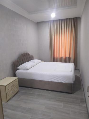 a bedroom with a large bed and a window at Alped in Zestafoni