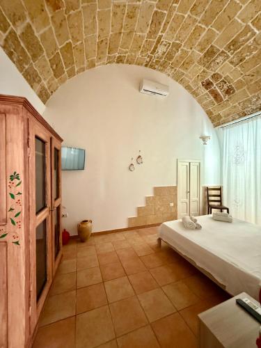 a bedroom with a bed and a stone ceiling at B&B NONNA TINA in Gemini