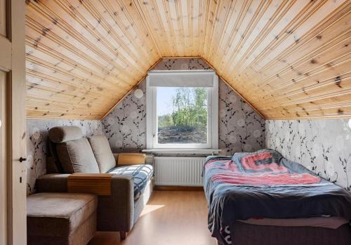 a small room with a bed and a couch and a window at Shared room in a quiet area in Kallinge