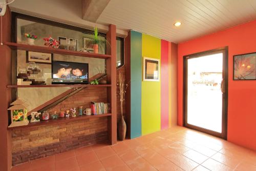 a hallway with colorful walls and a colorful door at See View Place in Chiang Rai