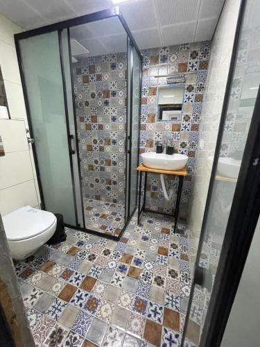a bathroom with a toilet and a sink at La Dimora Villas in Kaş