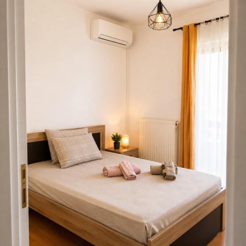a bedroom with a bed with two towels on it at Among the pines in Katakolo