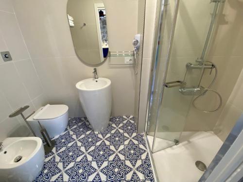 a bathroom with a shower and a toilet and a sink at Cinquestelle Albergo del centro storico in Palinuro