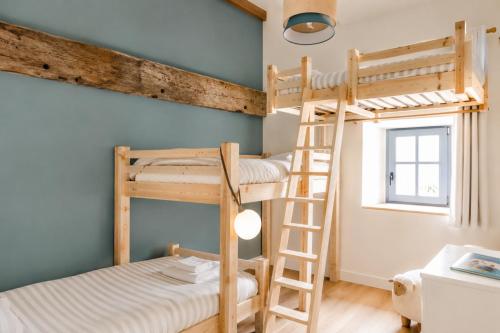a room with two bunk beds and a window at La borderie de Beauregard in Treize-Vents