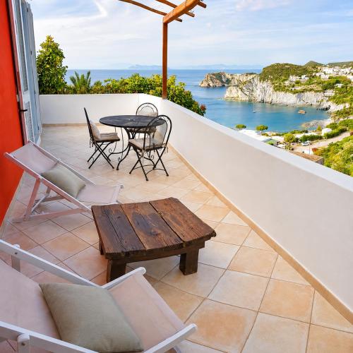 a balcony with a table and chairs and a view of the ocean at Maridea - La Marina in Ponza