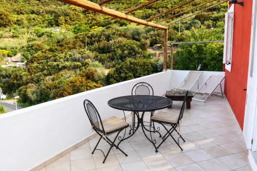 a patio with a table and chairs on a balcony at Maridea - La Marina in Ponza