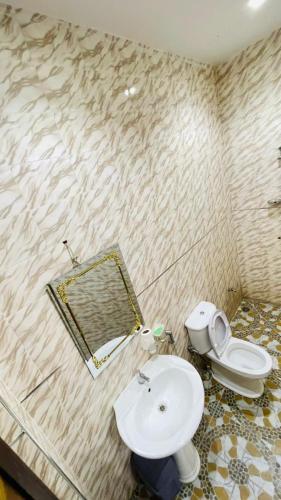a bathroom with a toilet and a sink at Residence ADN Walo in Richard Toll