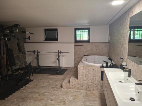 a bathroom with a tub and a sink at Apartmán Palza Jablonec in Jablonec nad Nisou