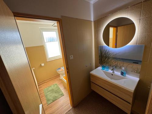 a bathroom with a sink and a mirror at Pension Haus Beckmann in Borkum
