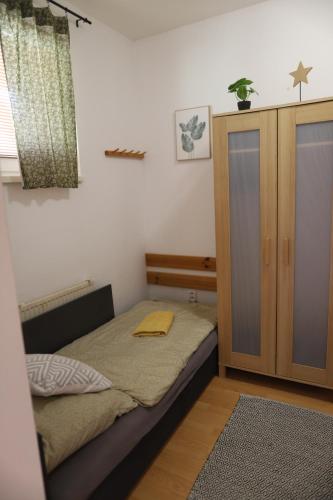 a small bedroom with a bed and a cabinet at Apartmán PT Donovaly in Donovaly