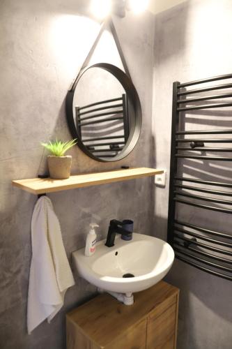 a bathroom with a sink and a mirror at Apartmán PT Donovaly in Donovaly