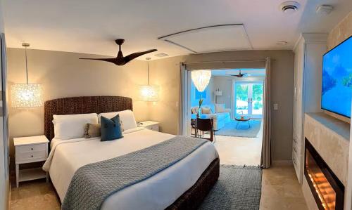 a bedroom with a large bed and a tv at Sunset Reef St. Kitts in Ottleyʼs