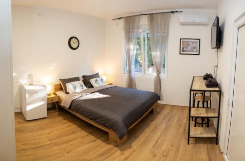 a bedroom with a bed and a window at Naissus Apartments in Niš